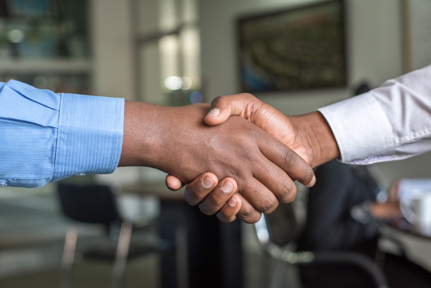 Two business professionals shaking hands after a successful hiring agreement